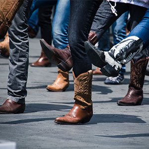 close-up of boots of a group of people line dancing