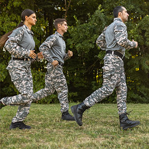three military members on a run outdoors