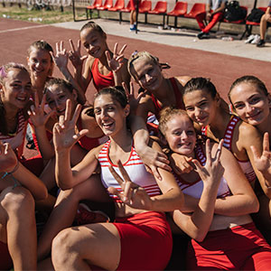 group of women's track athletes posing together for a photo